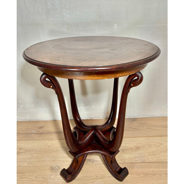 Elegant early 20th century Art Nouveau side table crafted in solid oak with a beautifully sculptural pedestal base. The...