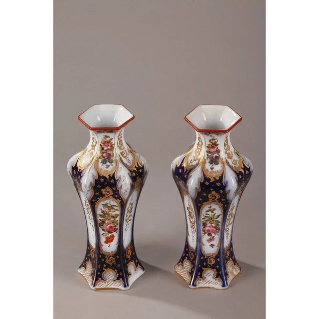 Pair of hexagonal porcelain vases decorated with multicolored flowers. The midnight blue background is highlighted with...
