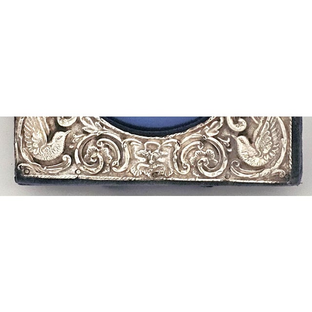 A beautifully expressive Art Nouveau sterling silver picture frame, hallmarked Birmingham, England, 1905, featuring an...