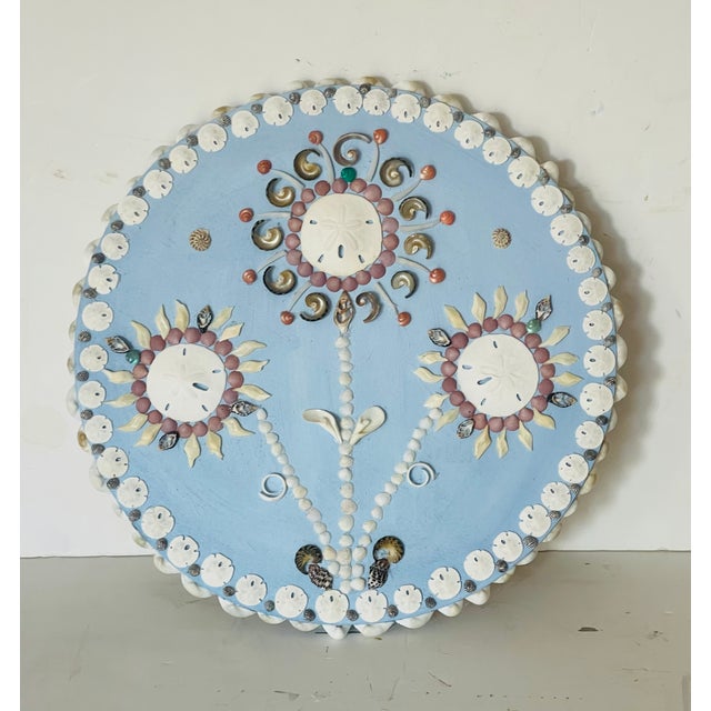 Unique shell art collage on round wood plaque Rose on Blue designed and created by Elia.