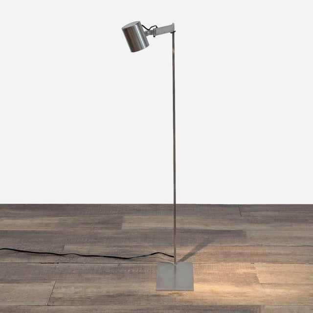 Chrome floor lamp with adjustable arm. Brand: Christian Liaigre. Original Price: $1900. Dimensions (in): 7W x 12D x 46H.