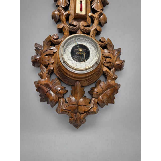 Black Forest Style Carved Aneroid Barometer and Thermometer, c. 1890 A finely carved Continental wall barometer and...