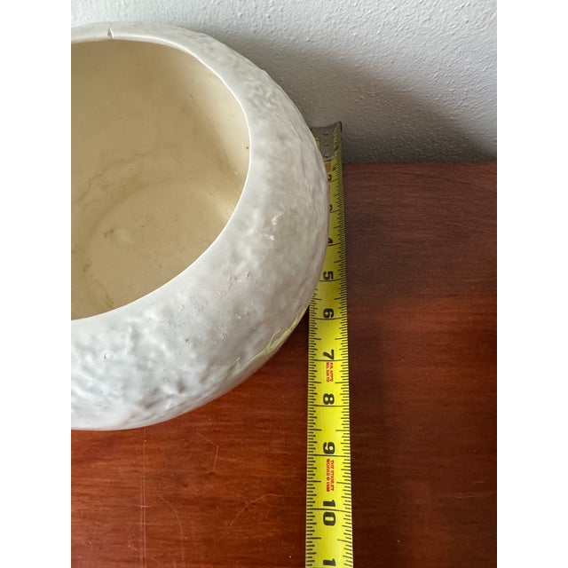 Bring understated elegance and collectible charm into your space with this vintage ceramic bowl by Ruddell Pottery, a mid-...