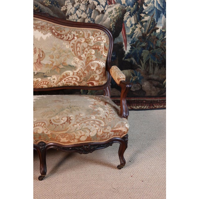 A beautiful Napoleon III period carved walnut salon seating set, comprising a large sofa, four armchairs, four chairs, and...