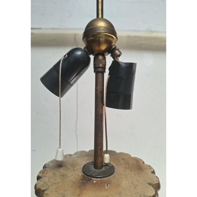 A striking vintage floor lamp made in Italy, featuring an ornate sculptural column finished in antique gold with warm...