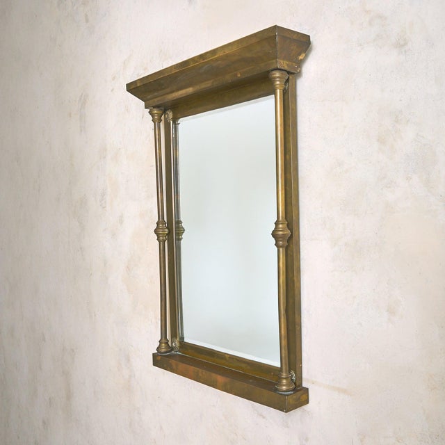 A large, mid-20th-century Italian brass wall mirror shaped with architectural grandeur. Standing at 45.5 inches tall, the...
