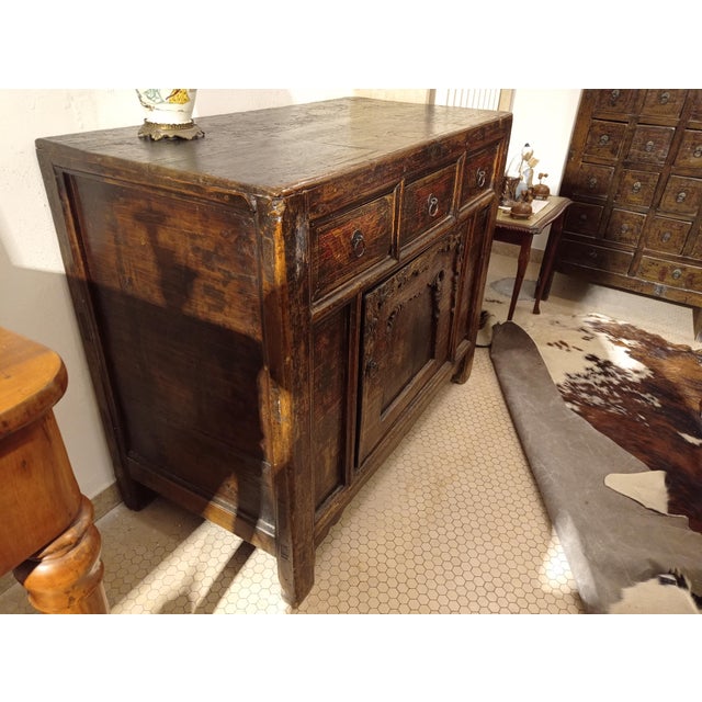 The sideboard has decorations on the front.