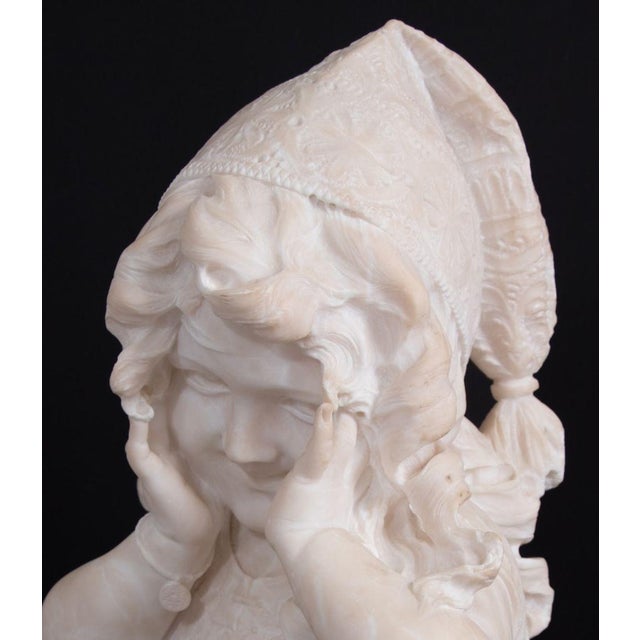 Emilio Fiaschi (Italian, 1858-1941) Neapolitan Girl Alabaster Bust, late 19th century, depicting a young girl hiding her...
