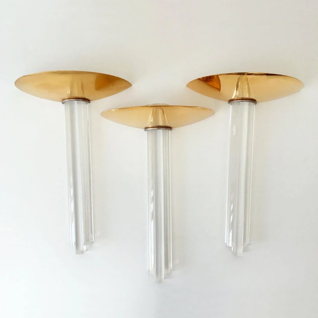 - Three Hollywood Regency style wall lights - Made of gilt brass and acrylic glass - Manufactured in the 1980s in Italy -...