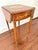 A single drawer Maitland-Smith drop leaf side table featuring a refined oval form, slender tapered legs, and classic...