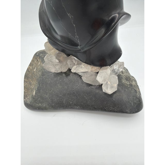 This is a great piece. Made of carved stone and Bone by inuits of Greenland Denmark. He's standing in a clumpmof crystals...