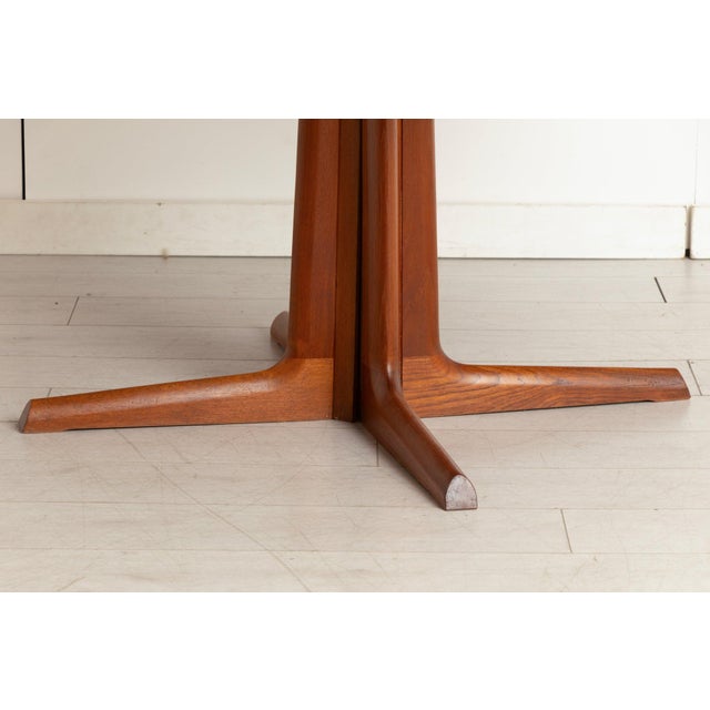 A midcentury danish extending dining table in teak, produced by gudme møbelfabrik and bearing the danish furnituremakers’...
