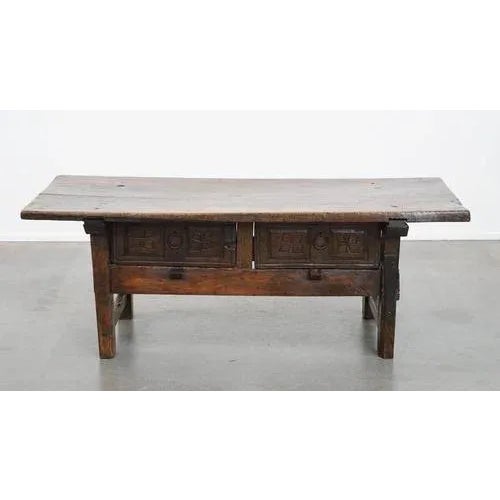 Offered this sturdy and characterful antique Spanish coffee table from the 17th century with two drawers and a beautiful...