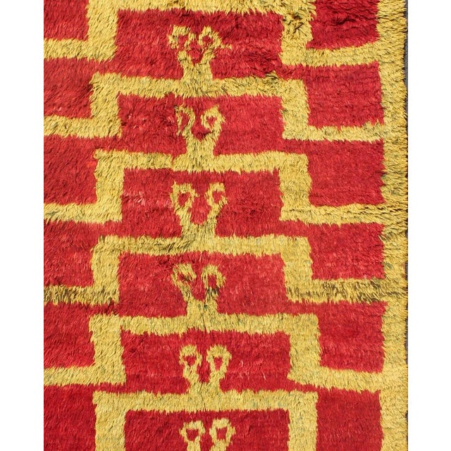 Made with fine wool and high pile, this vintage Tulu from mid-20th century Turkey boasts an interconnected Mid-Century...