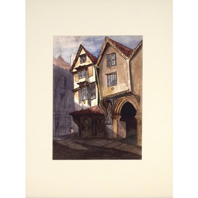 Antique English watercolor of tudor houses on a city street. Late 19th to early 20th century. Presented in cream colored...