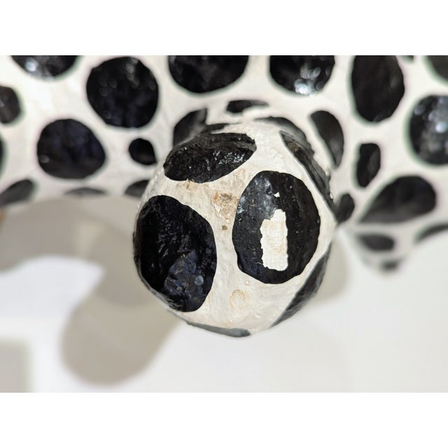 Contemporary American folk art sculpture by Debbie Edgers Sturges. Hand-painted black-and-ivory papier-mâché dog with...