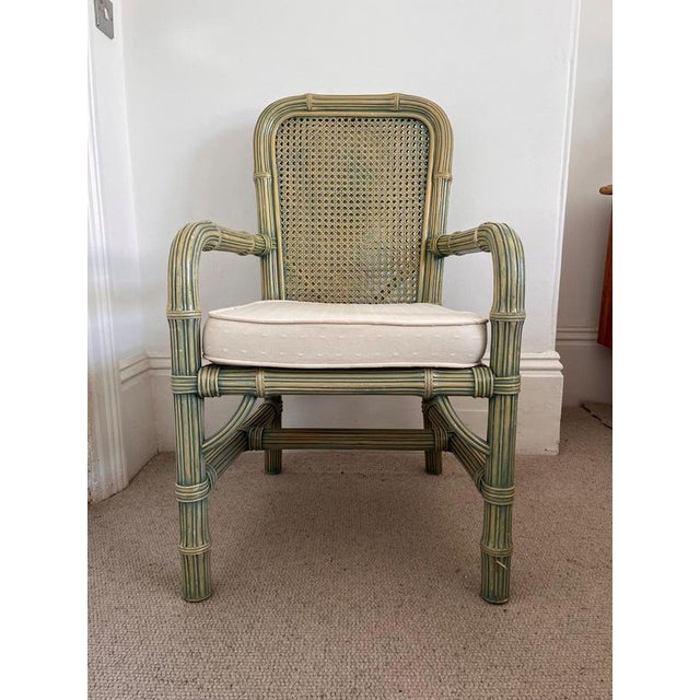 A pair of 80s faux Bamboo dining chairs with cane back and cushioned seat The chairs have a green wash effect dimensions...