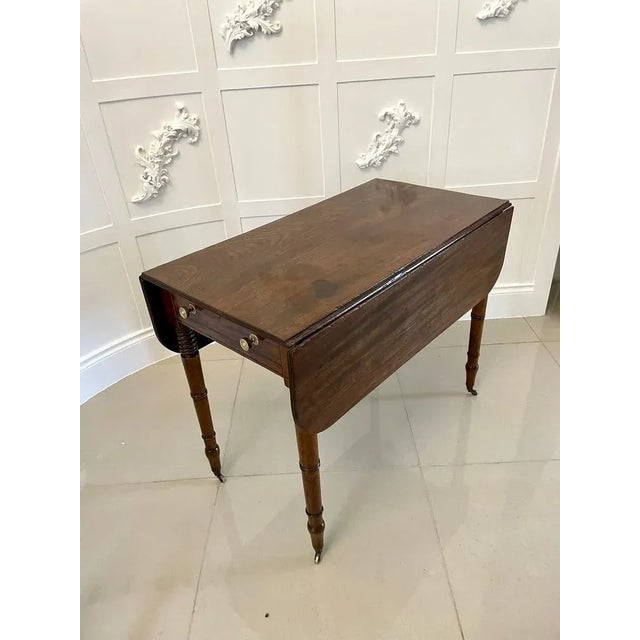 Antique George III quality mahogany Pembroke table having a quality mahogany top with two drop leaves and a reeded edge,...
