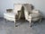 An elegant pair of vintage Hollywood Regency bergère armchairs inspired by classic French Louis XV design. These...