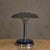 A French Art Deco table lamp in chrome and cobalt glass, dating to the 1950s. The wide domed shade rests lightly above a...