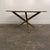 Elegant mid-century modern Italian table featuring a polished marble top set on a sculptural three-leg brass base. The...