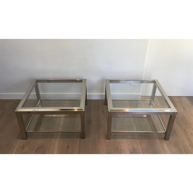 This large pair of side tables is made of chromed with glass shelves. The top glass shelves are inserted in a chromed...