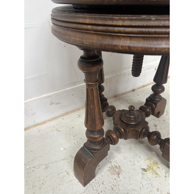 Solid walnut piano stool Four turned legs with recessed fluting Support stretcher Height-adjustable fabric seat Good...