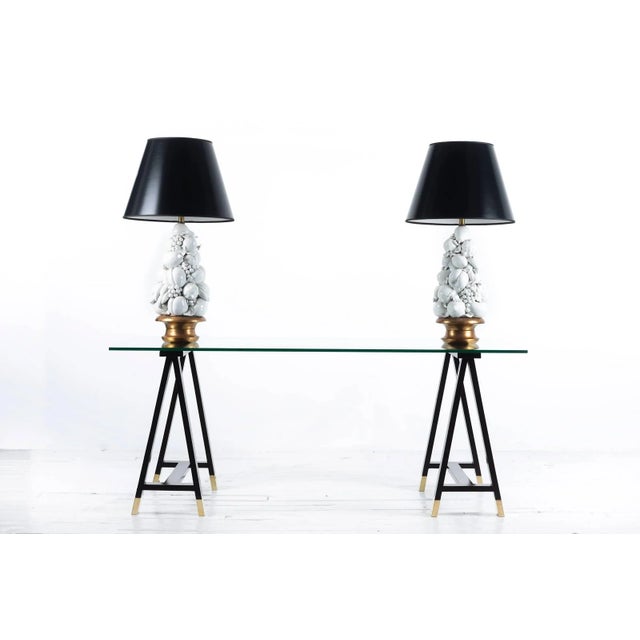 Arturo Pani Campaign style, mahogany trestle table with brass escutcheons with glass top. Designed by Pani for a family...