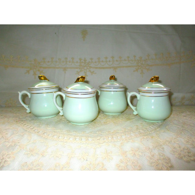 This is a Beautiful Vintage Set of Four Neiman Marcus Light Green Porcelain Soup Pots De Creame with Lids that have a Gold...