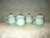 This is a Beautiful Vintage Set of Four Neiman Marcus Light Green Porcelain Soup Pots De Creame with Lids that have a Gold...