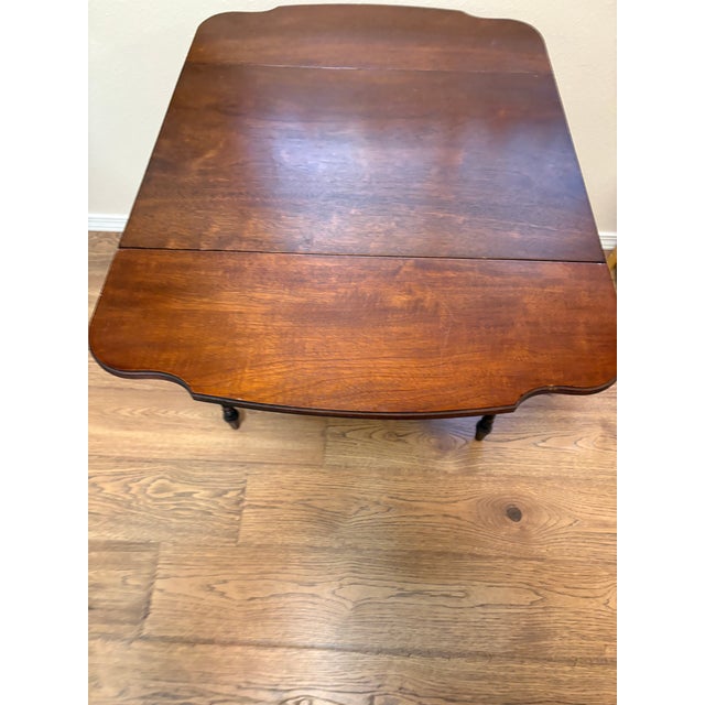 This occasional table features spiral legs, drop leaf sides and a drawer to hold items. It has felt tips on bottom for...