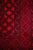 Rug in dark red with elephant footprint motif. The main material is wool, as is the pile of the rug. The rug is hand-...