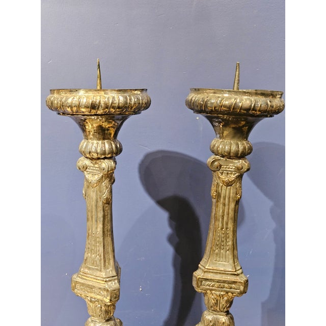 Antique Spanish Colonial Brass Repousse candelsticks with silver finish and candle prickets.