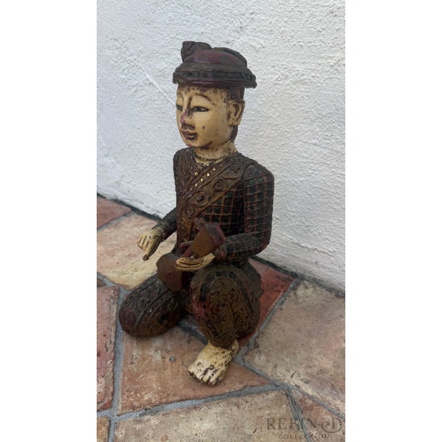Hand-Carved Chinese Wooden Figural Sculpture of Seated Musician with String Instrument Description This expressive hand-...