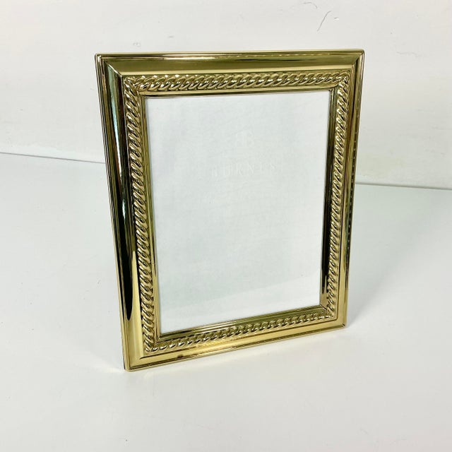 This is a beautiful tabletop Brass Picture Frame. It will host a 8” x 10” photograph. The lacquered brass frame features a...