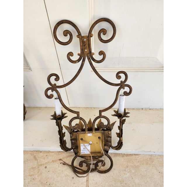 Great looking pair of gilt metal two light wall sconces. There are a total of four pairs available.