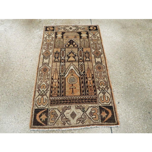 An antique East Turkestan Khotan throw rug. Possibly Khotanese. This amusing scatter schematically depicts a mosque...