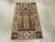 An antique East Turkestan Khotan throw rug. Possibly Khotanese. This amusing scatter schematically depicts a mosque...