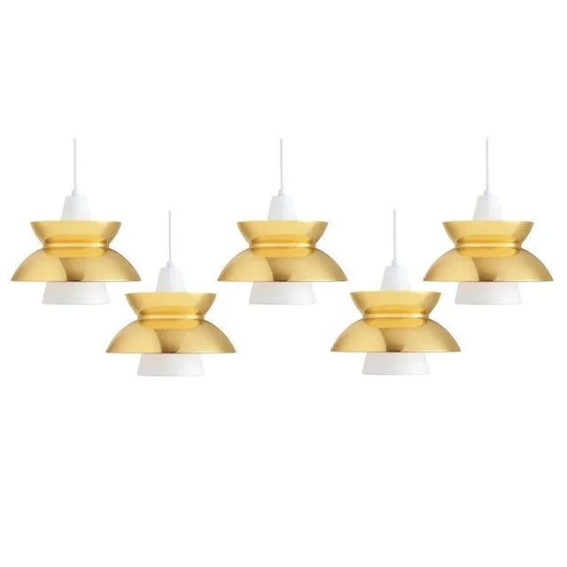 'Doo-Wop' Pendant by Jørn Utzon for Louis Poulsen in Brass. Originally introduced in the 1950s, the 'Doo-Wop' pendant...