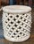 A Tucker Robbins ceramic table in an ecru hue, inspired by the shape of the Bamileke tables from Cameroon. This ceramic...