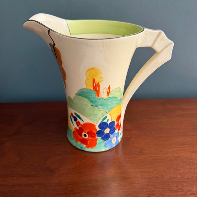 A striking and highly collectible Clarice Cliff daffodil shape jug in the sought-after “Secrets” pattern, dating to circa...