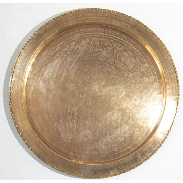 Large vintage Asian handcrafted round tray with a patina from the 1950s. The tray features a hanging hook, allowing it to...