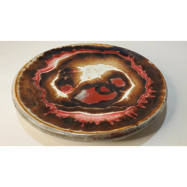 This is a great decorative pottery plate from St. Louis. It would be a wonderful catchall or displayed.