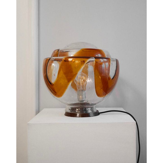 This Italian vintage lamp dates back to the 1970s. Its spherical shape creates beautiful depth and a pleasant, warm light...