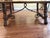Elegant Spanish/Tuscan-style solid maple dining table with a striking curved iron stretcher base and substantial carved...