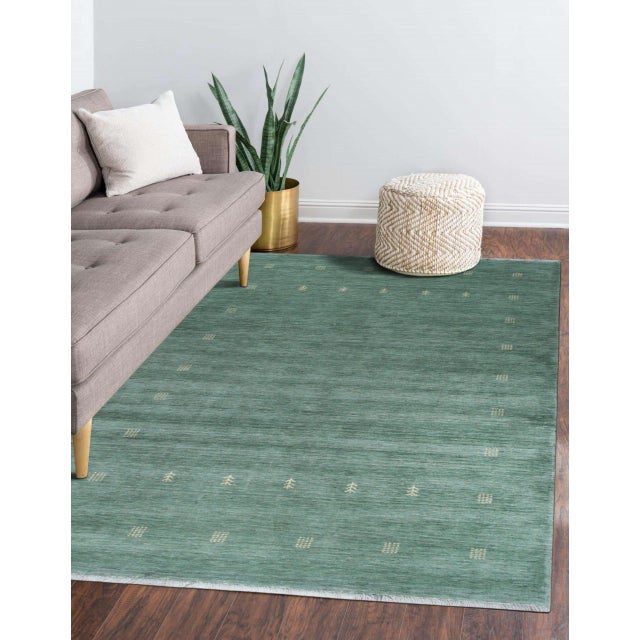 Laine Amara Green Handmade Wool Rug, Country of Origin: India. This exceptional piece exemplifies the modern evolution of...