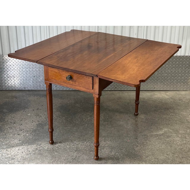 Beautiful dropleaf table circa early 19th century. Solid cherry construction, drop leafs with decorative “ovolo” scalloped...