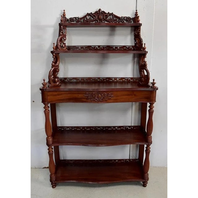 Solid and veneered mahogany furniture, Napoleon III period, composed of a console in the lower part. It offers a drawer in...