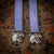 A vintage 20th century english solid silver and blue silk bookmark. Either end of the silk ribbon are two tiger faces with...
