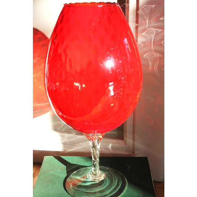 This striking vintage pedestal vase showcases the bold elegance of Mid-Century Modern art glass. Crafted from vibrant ruby...